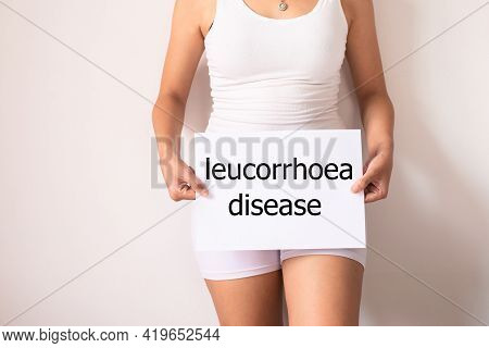 Women Hands Holding A White Sign With The Word Leucorrhoea Disease On White Background