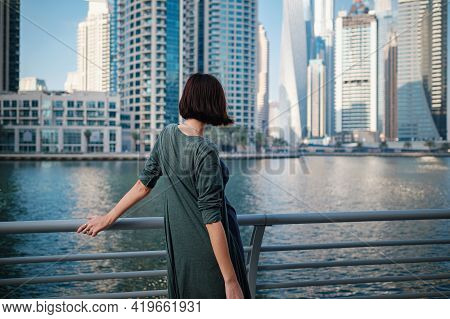 Happy Young Female Traveler In The Big City Of Dubai, Uae