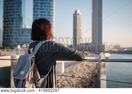Happy Young Female Traveler In The Big City Of Dubai, Uae