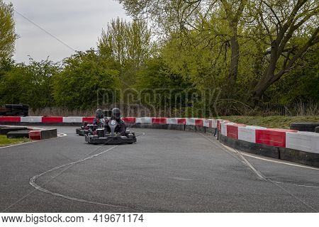 A Shot Of A Racing Kart As It Circuits A Track.