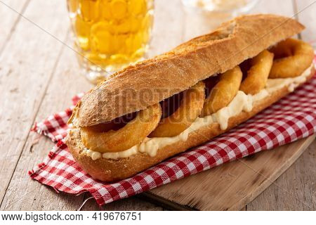 Calamari Rings Sandwich With Beer On Wooden Table. Typica Spanish Food