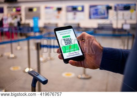 health Vaccine Passport for Coronavirus or Covid-19. Traveller Using Mobile Phone with Vaccination in Immune Status to Certificated International Traveling in Airport