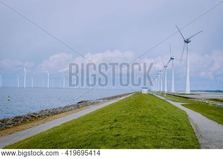 Offshore Windmill Farm In The Ocean Westermeerwind Park, Windmills Isolated At Sea On A Beautiful Br