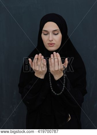 Portrait of young Muslim woman making dua