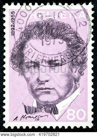 Switzerland - Circa 1972: A Post Stamp Printed In Switzerland Shows A Portrait Of Oscar Arthur Honeg