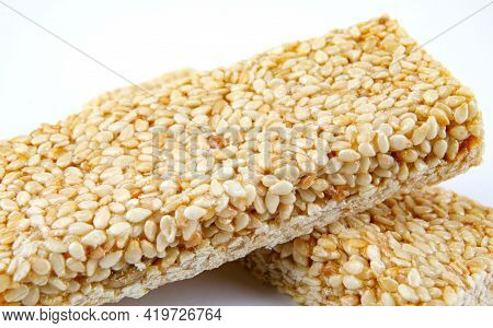 Two Tiles Of Sesame Kozinak On A White Background.