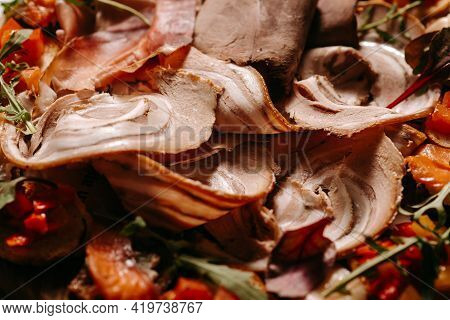 A Plate Of Assorted Meat With Cooked Vegetables,