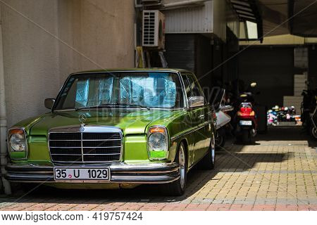 Alanya, Turkey - April 17 2021:  Green  Mercedes-benz W114/w115    Is Parked  On The Street On A War