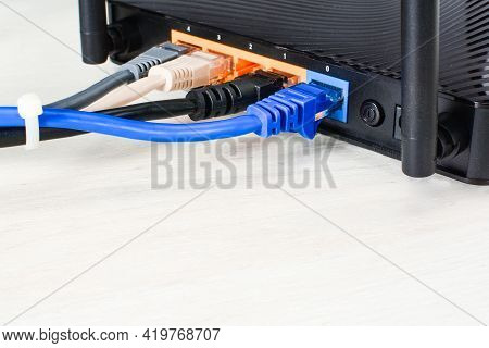 Home Wi-fi Router For Internet Connection With Four Patch Cords And Cable Tie. Concept Home Network,