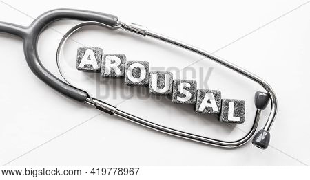 Stone Block Form Word Arousal With Stethoscope. White Background. Medical Concept. State Of Being Aw