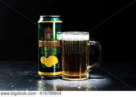 Can Of Perlenbacher Radler Beer And Beer Glass On Dark Background. Illustrative Editorial Photo Shot