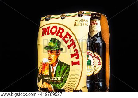 6 Pack Of Birra Moretti Beer On Wooden Barrel With Dark Background. Illustrative Editorial Photo Buc