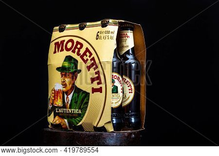 6 Pack Of Birra Moretti Beer On Wooden Barrel With Dark Background. Illustrative Editorial Photo Buc