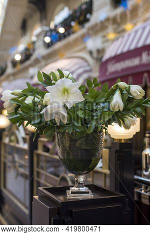 White Amaryllis Flowers In A Steel Vase Are As A Decoration For The Dining Table.