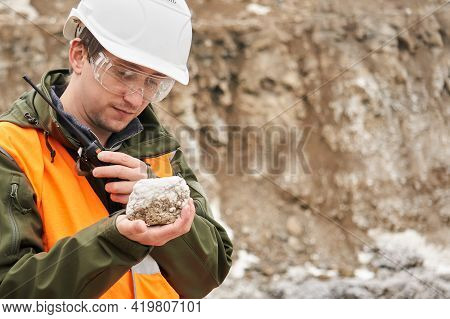 A Man Geologist Examines A Mineral Sample