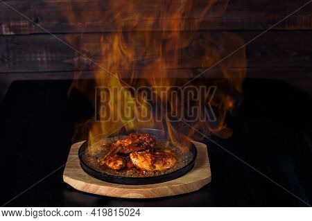 Fajitos, Meat In A Frying Pan With Fire On A Wooden Tray, Beautiful Serving, Dark Background.