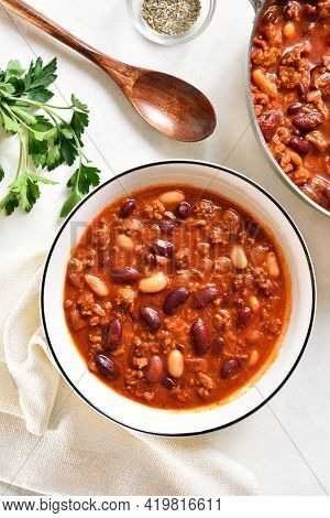 Cowboy Beans With Ground Beef, Jalapeno Pepper And Bacon In Bowl Over Light Stone Background. Top Vi