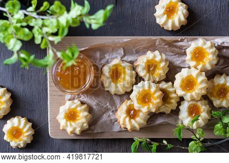 Homemade Shortbread Cookies Qurabiya With Orange Jam In The Center On A Baking Paper On Grey Wooden 