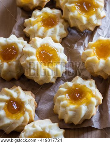 Homemade Shortbread Cookies Qurabiya With Orange Jam In The Center On A Baking Paper. Close-up, Sele