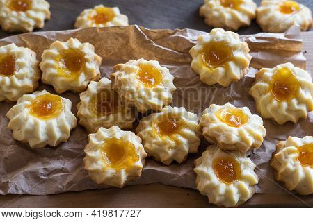Homemade Shortbread Cookies Qurabiya With Orange Jam In The Center On A Baking Paper. Close-up, Sele