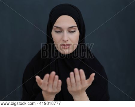 Portrait of young Muslim woman making dua