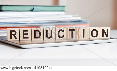 The Word Reduction Is Written On Wooden Cubes, Concept