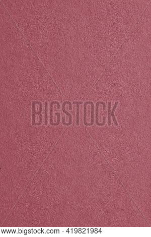 The Surface Of Dark Red Cardboard. Paper Texture With Cellulose Fibers. Vertical Purple-brown Tinted