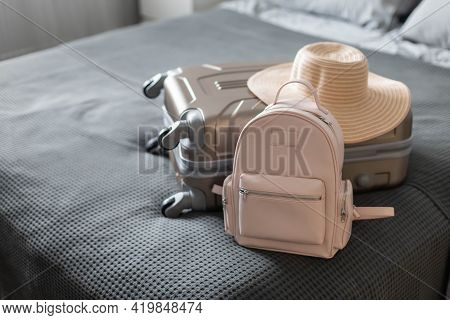 Modern Suitcase Full Of Things, Handbag And Straw Hat. Baggage Case Packing Getting Ready To Travel