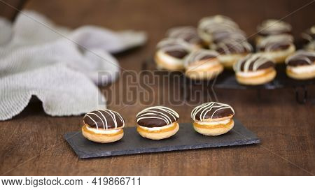 Cakes Boucher On The Black Plate, Sweet Fresh Pastries.
