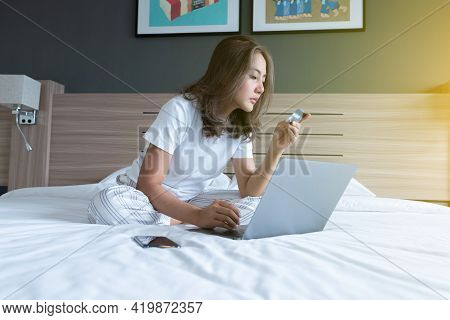 Women On The Bed With Laptop And Credit Card
