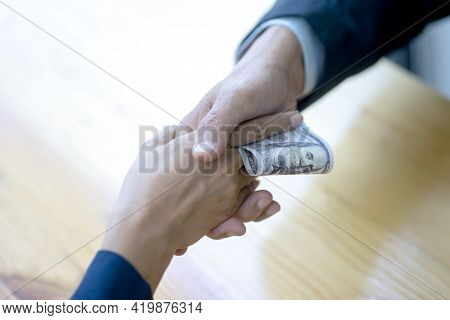 A Businessman Or Official Is Accepting Money Handed Over