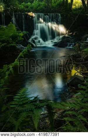 Waterfall Near The River Beach Of Mamoa