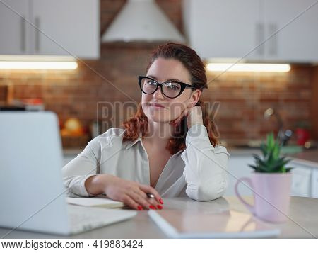 Businesswoman Working On Laptop Computer Sitting At Home