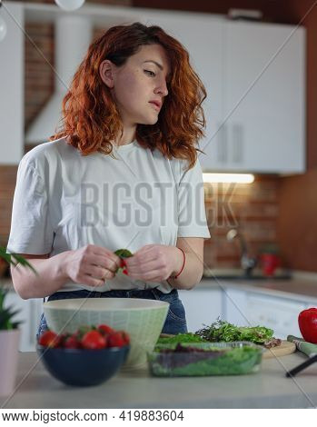 Young Pretty Woman Blogger Shoots A Video Of A Salad Recipe On A Smartphone Camera.
