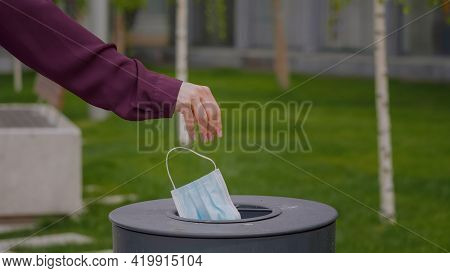 Close Up Mask Throw In A Trash.  Over Coronavirus. Concept End Of Virus Pandemic.