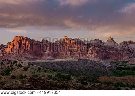 Sunset Lights Up The Red Cliffs Of Captiol Reef National Park In Utah