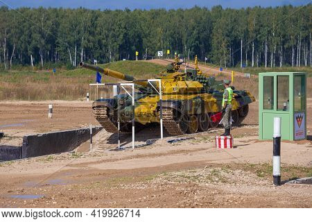 Alabino, Russia - August 25, 2020: Yellow T-72b3 Tank Of Uzbekistan Team On The Tank Biathlon Track