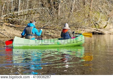 Family Canoeing On The River In The Early Morning. Joint Pastime, Entertainment, Outdoor Recreation,