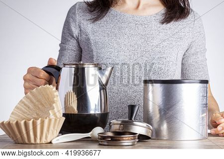 A Young Caucasian Woman Is Preparing Coffee On Table Using A Percolator Filter Papers And A Jar Of C