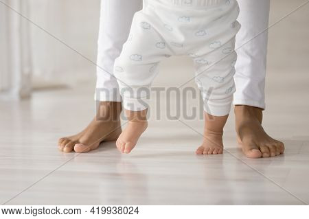 Close Up Of Small Toddler Baby Make First Steps