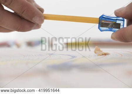 Pencil Sharpenerand Shavings On A White Background