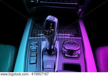 Automatic Gear Stick (transmission) Of A Modern Car In Blue And Pink Tones. Multimedia And Navigatio