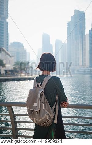 Happy Young Female Traveler In The Big City Of Dubai, Uae