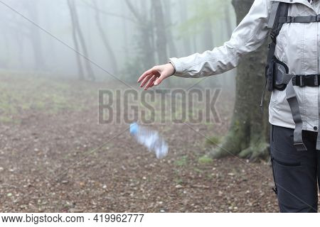 Close Up Of An Uncivil Trekker Throwing Garbage To The Ground In Nature