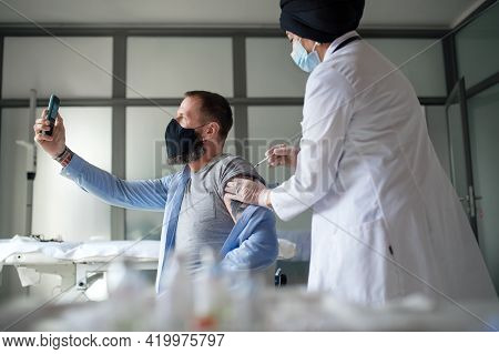 Man Taking Selfie When Getting Vacinated, Coronavirus And Vaccination Concept.