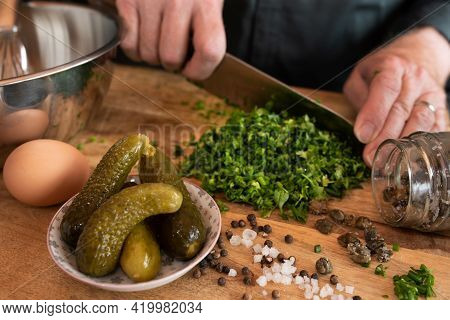 Preparing A Gribiche Sauce For Green Asparagus. Hands Prepare Fresh Ingredients For A Tasty Side Dis