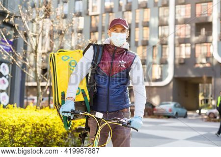 Kiev, Ukraine - April 28, 2021: Glovo Bike Courier On The Street. Delivery Boy Of Glovo Delivery Ser
