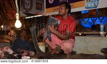 Siliguri - India 
March 2021 
An Indian Fish Seller Or Person With A Sliced Fish In His Hand At A Lo