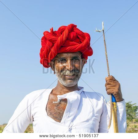 A Rajasthani Tribal Man Wearing Traditional Colorful Turban And Loves To Pose