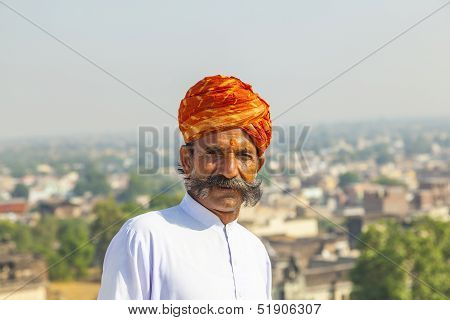 Rajasthani Man With Bright Red Turban And Bushy Mustache Poses For Tourists